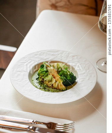 Roasted cauliflower steak with broccoli and herbs Roasted cauliflower steak with broccoli and herbs 135881591