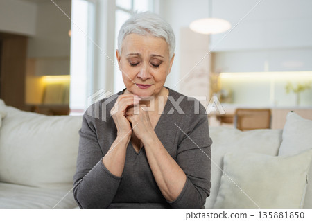 Sad tired ill sick lonely disappointed older senior woman sitting at home alone. Unhappy mature grandmother experiencing grief relative death bad news. Stressed elder lady suffering from loneliness Sad tired ill sick lonely disappointed older senior woman sitting at home alone. Unhappy mature grandmother experiencing grief relative death bad news. Stressed elder lady suffering from loneliness 135881850