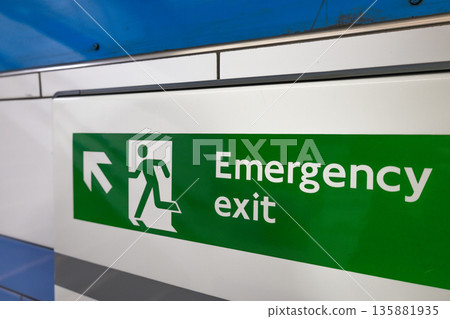 Green Emergency Exit Sign in Metro Station 135881935