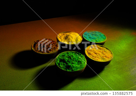 colorful rainbow holi paint color powder explosion isolated on dark black background. colorful rainbow holi paint color powder explosion isolated on dark black background. 135882575
