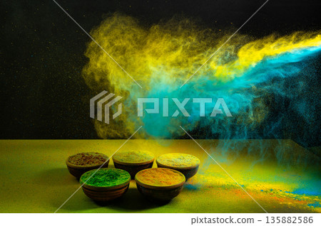 colorful rainbow holi paint color powder explosion isolated on dark black background. colorful rainbow holi paint color powder explosion isolated on dark black background. 135882586