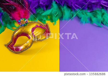 Vibrant Mardi Gras background with mask, beads, and festive decorations Vibrant Mardi Gras background with mask, beads, and festive decorations 135882686