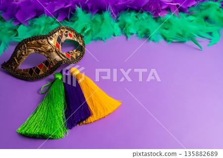 Vibrant Mardi Gras background with mask, beads, and festive decorations 135882689