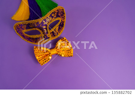Vibrant Mardi Gras background with mask, beads, and festive decorations Vibrant Mardi Gras background with mask, beads, and festive decorations 135882702