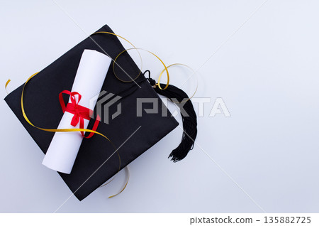 A symbolic representation of global education, graduation. graduation cap, books, globe and diploma on a colorful background. A symbolic representation of global education, graduation. graduation cap, books, globe and diploma on a colorful background. 135882725