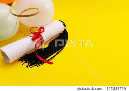 A symbolic representation of global education, graduation. graduation cap, books, globe and diploma on a colorful background. A symbolic representation of global education, graduation. graduation cap, books, globe and diploma on a colorful background. 135882739