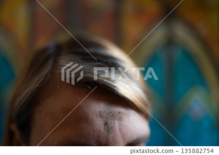 Ash Wednesday celebrations in church on stained glass window. 135882754