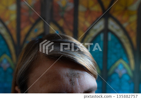 Ash Wednesday celebrations in church on stained glass window. 135882757