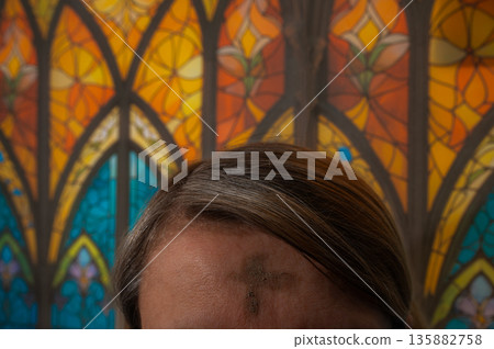 Ash Wednesday celebrations in church on stained glass window. 135882758