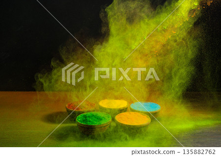 colorful rainbow holi paint color powder explosion isolated on dark black background. 135882762