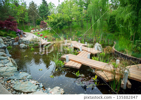 Wooden zigzag Japanese bridge in   Japanese garden in Krasnodar 135882847