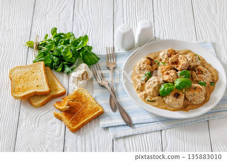 Chicken meatballs in creamy sun dried tomato sauce 135883010