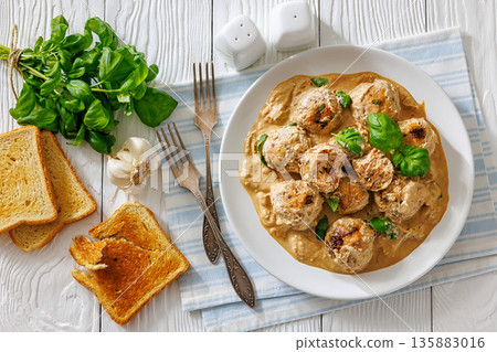 Chicken meatballs in creamy sun dried tomato sauce 135883016