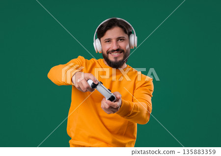 Excited Gamer Man Playing Online Video Game On Console With Gamepad On green Excited Gamer Man Playing Online Video Game On Console With Gamepad On green 135883359