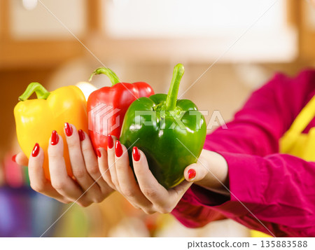 Woman holding bell peppers paprika 135883588