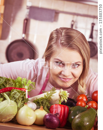 Woman having vegetables on table Woman having vegetables on table 135883750