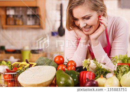 Woman having vegetables on table 135883751