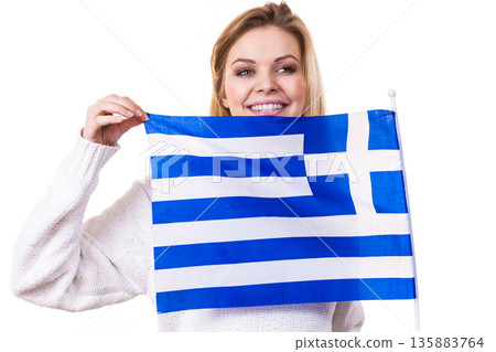 Happy woman holding Greek national flag Happy woman holding Greek national flag 135883764