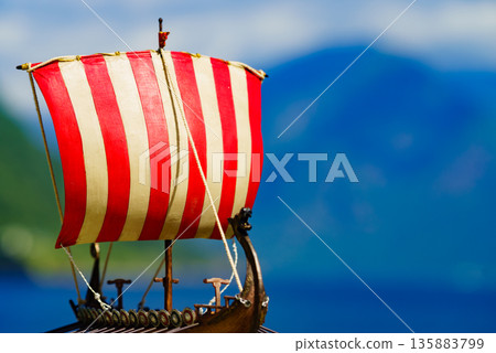 Viking boat on fjord shore, Norway 135883799