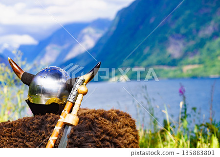 Viking helmet on fjord shore, Norway Viking helmet on fjord shore, Norway 135883801