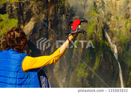 Drone in female hand against nature Drone in female hand against nature 135883832