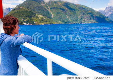 Tourist woman on ferryboat, Norway Tourist woman on ferryboat, Norway 135883836