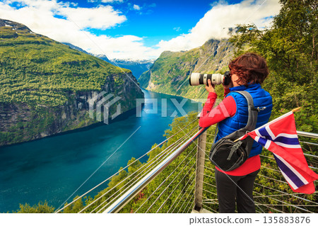 Tourist taking photo of fjord landscape, Norway 135883876