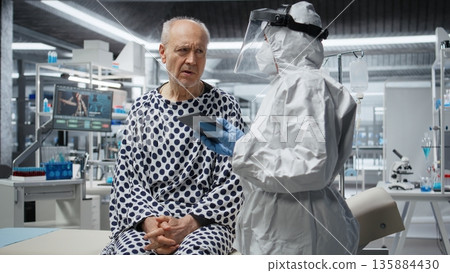 Researcher in secured lab treating infected patient in quarantine, recording virus symptoms and analyzing drug efficacy to develop a vaccine and breakthrough in medical protection. Camera A. Researcher in secured lab treating infected patient in quarantine, recording virus symptoms and analyzing drug efficacy to develop a vaccine and breakthrough in medical protection. Camera A. 135884430