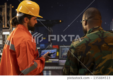 Armed forces soldier maintaining presence on offshore platform late at night to deter insurgent criminal attacks. Naval unit on drilling barge under aurora borealis northern lights sky 135884513