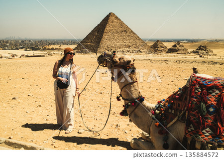 Woman Looking With Care In The Eyes Of A Camel 135884572