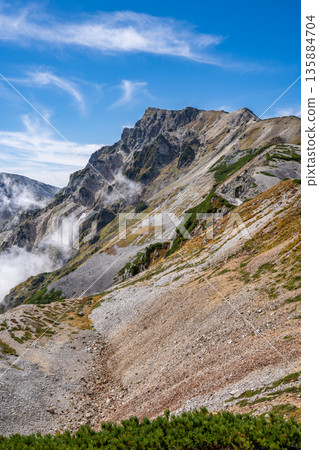 View of Mt. Hakuba in the Ushiro-Tateyama mountain range from Mt. Korenge. Traverse from Hakuba-Oike to Mt. Hakuba in the Northern Alps. View of Mt. Hakuba in the Ushiro-Tateyama mountain range from Mt. Korenge. Traverse from Hakuba-Oike to Mt. Hakuba in the Northern Alps. 135884704