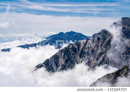 View of Mt. Karamatsu and Mt. Goryu in the Ushiro-Tateyama mountain range from Mt. Korenge. Traverse from Hakuba-Oike to Mt. Hakuba in the Northern Alps. View of Mt. Karamatsu and Mt. Goryu in the Ushiro-Tateyama mountain range from Mt. Korenge. Traverse from Hakuba-Oike to Mt. Hakuba in the Northern Alps. 135884707