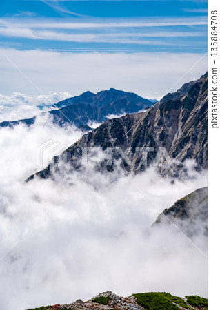 View of Mt. Karamatsu and Mt. Goryu in the Ushiro-Tateyama mountain range from Mt. Korenge. Traverse from Hakuba-Oike to Mt. Hakuba in the Northern Alps. 135884708