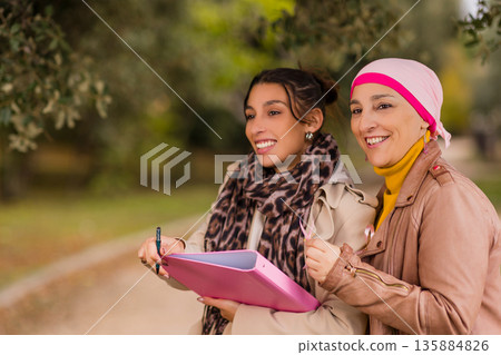Women volunteers collecting signatures for breast cancer awareness 135884826