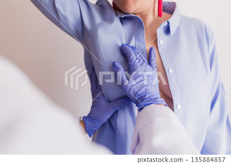 Doctor examining woman for early breast cancer detection 135884857