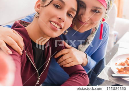 Daughter supporting mother during cancer recovery lunch 135884860