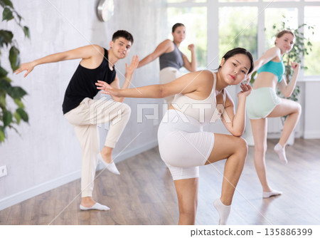 Asian girl perform choreographic exercise and teach energetic mobile social dance groove with friend Asian girl perform choreographic exercise and teach energetic mobile social dance groove with friend 135886399