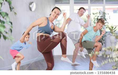Family with two children dancing in studio 135886438