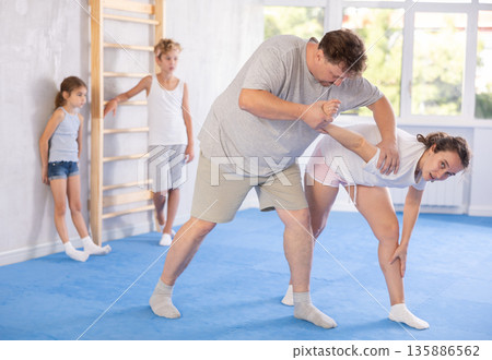 Man and woman training self-defense techniques 135886562