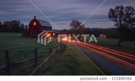 The tranquil beauty of a historic farm accentuated by the glowing light trails of cars that pass by bringing life to the quiet countryside The tranquil beauty of a historic farm accentuated by the glowing light trails of cars that pass by bringing life to the quiet countryside 135886568