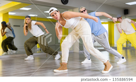 Young girl in cap dancing hip hop 135886594