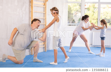 Parents and children during training and self-defense workout. 135886611