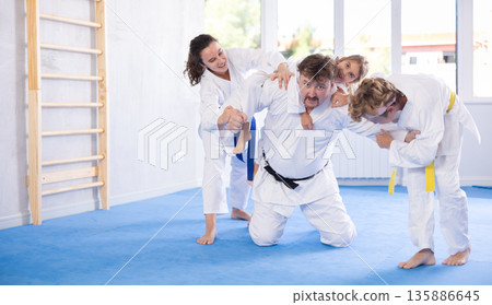 Family with children training karate fighting techniques Family with children training karate fighting techniques 135886645