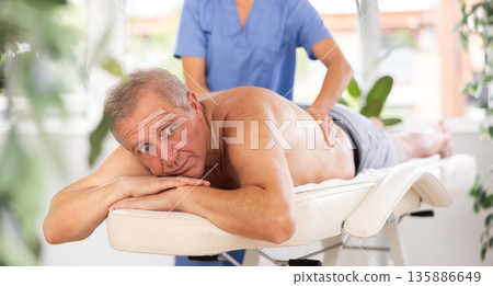 male patient having massage male patient having massage 135886649