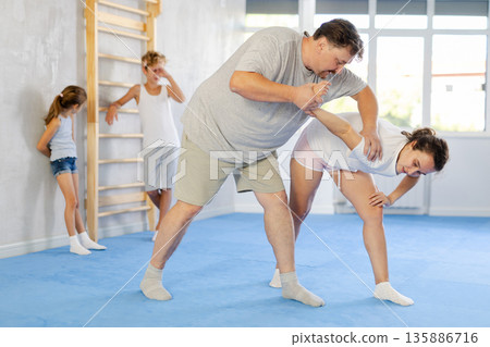 Man and woman training self-defense techniques 135886716