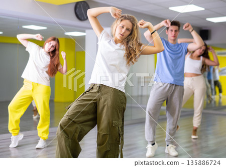 Boys and girls learn to dance dances in dance studio 135886724