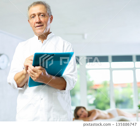 male masseur with folder 135886747