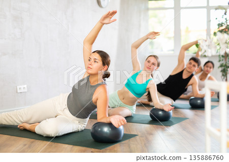 Group of young people doing softball pilates. 135886760