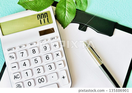 Binder and calculator showing estimates and purchases Binder and calculator showing estimates and purchases 135886901