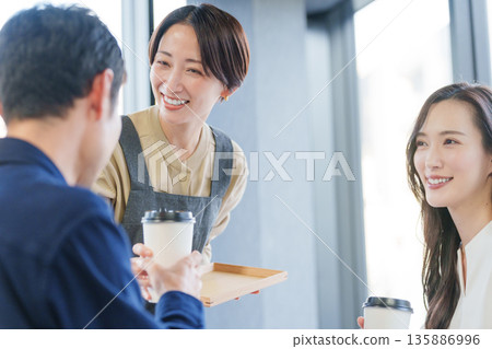 Female restaurant staff serving customers Female restaurant staff serving customers 135886996
